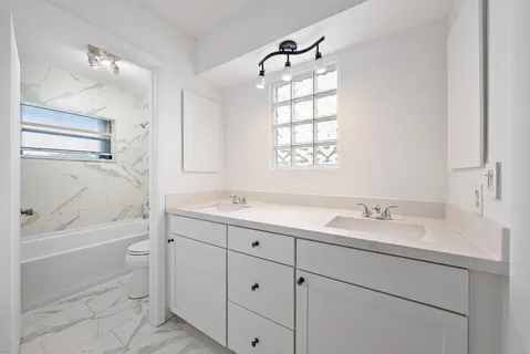 a bathroom with a toilet and a bathtub