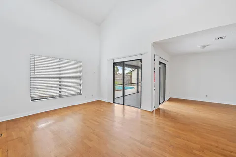a view of an empty room with glass door