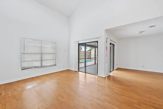 a view of an empty room with glass door