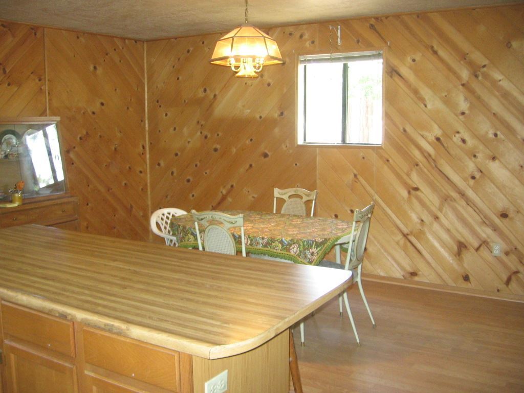 2860 Pine Rim Road Overgaard, AZ 85933 - Photo 4 of 6 a dining room with furniture and chandelier