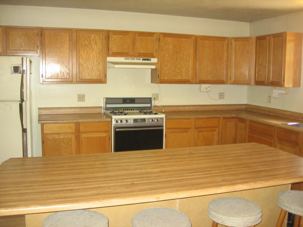 2860 Pine Rim Road Overgaard, AZ 85933 - Photo 6 of 6 a kitchen with stainless steel appliances wooden cabinets and a stove