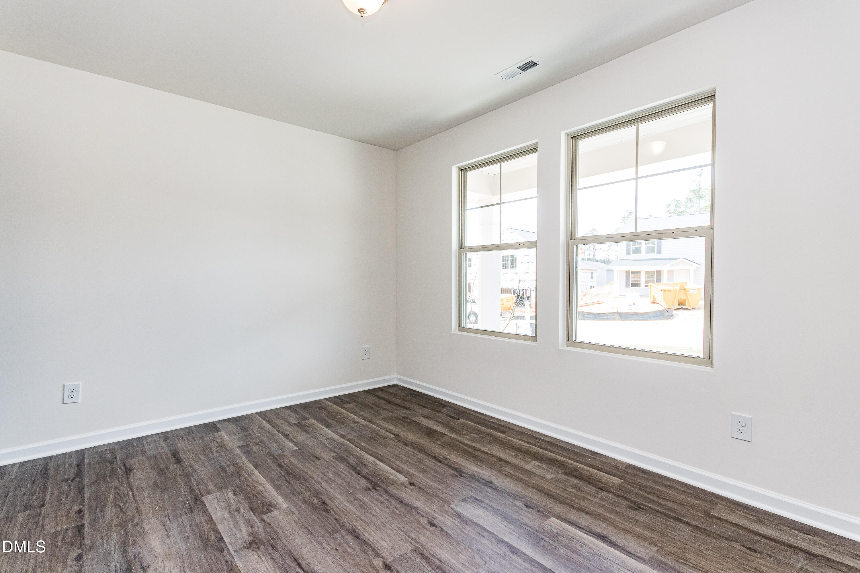 3309 Slippery Elm Drive Raleigh, NC 27610 - Photo 13 of 29 an empty room with wooden floor and windows
