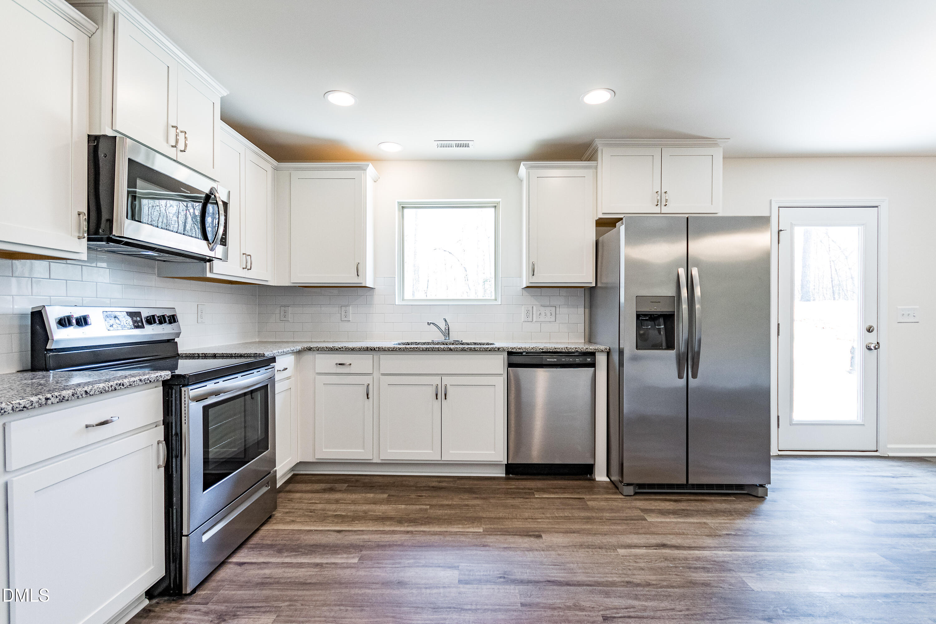 3309 Slippery Elm Drive Raleigh, NC 27610 - Photo 17 of 29 a kitchen with stainless steel appliances granite countertop a refrigerator sink and microwave