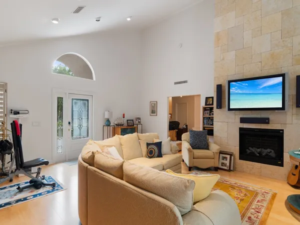 a living room with furniture a fireplace and a flat screen tv