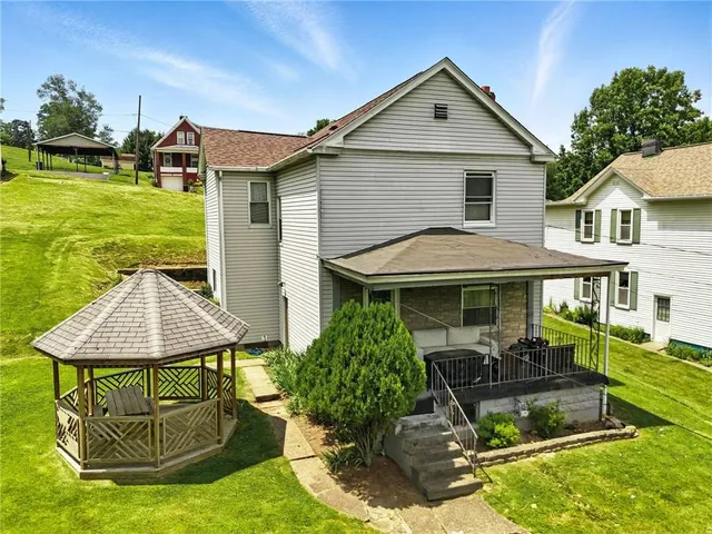 a front view of a house with garden