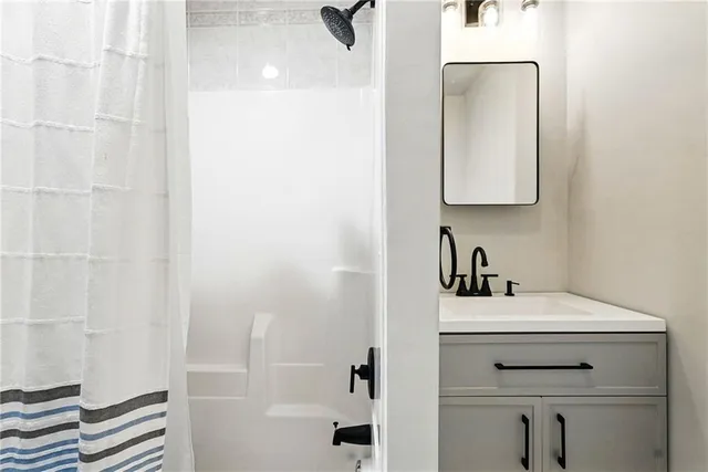 a bathroom with a sink vanity and a mirror