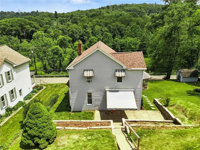 a aerial view of a house with a yard