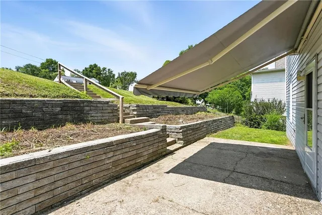 a view of a street with wooden fence