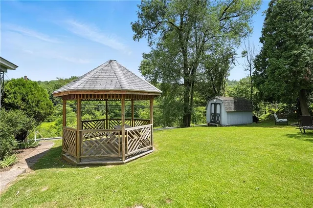 a view of a house with a yard and furniture
