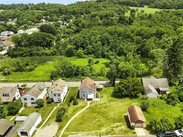 an aerial view of a house with yard swimming pool and outdoor seating