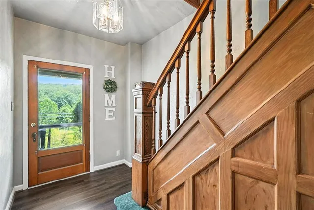 a view of an entryway with wooden floor and stairs