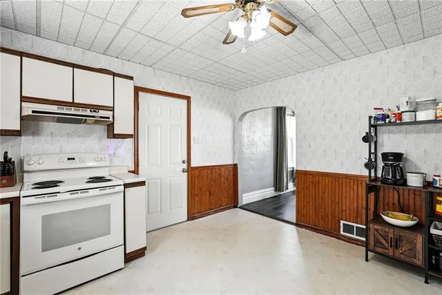 a kitchen with stainless steel appliances granite countertop a stove and a refrigerator