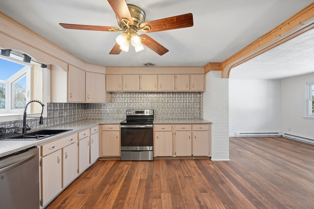 325 Granby Road Chicopee, MA 01013 - Photo 11 of 36 a kitchen with granite countertop a sink cabinets stainless steel appliances and a counter space