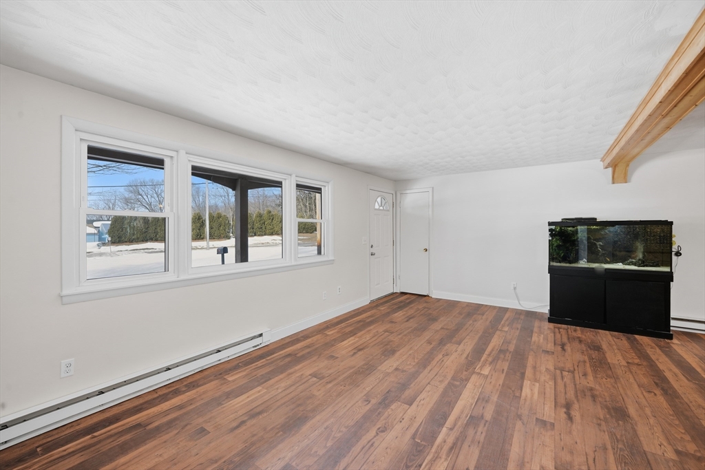 325 Granby Road Chicopee, MA 01013 - Photo 14 of 36 a view of empty room with wooden floor and fan
