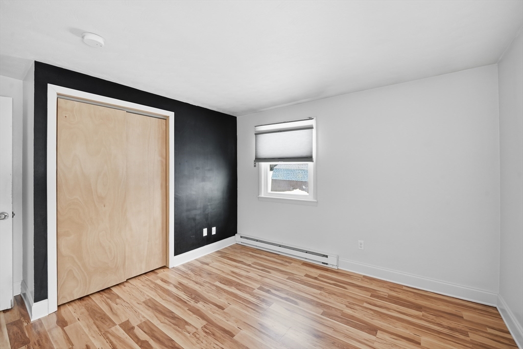 325 Granby Road Chicopee, MA 01013 - Photo 23 of 36 a view of empty room with wooden floor and fan