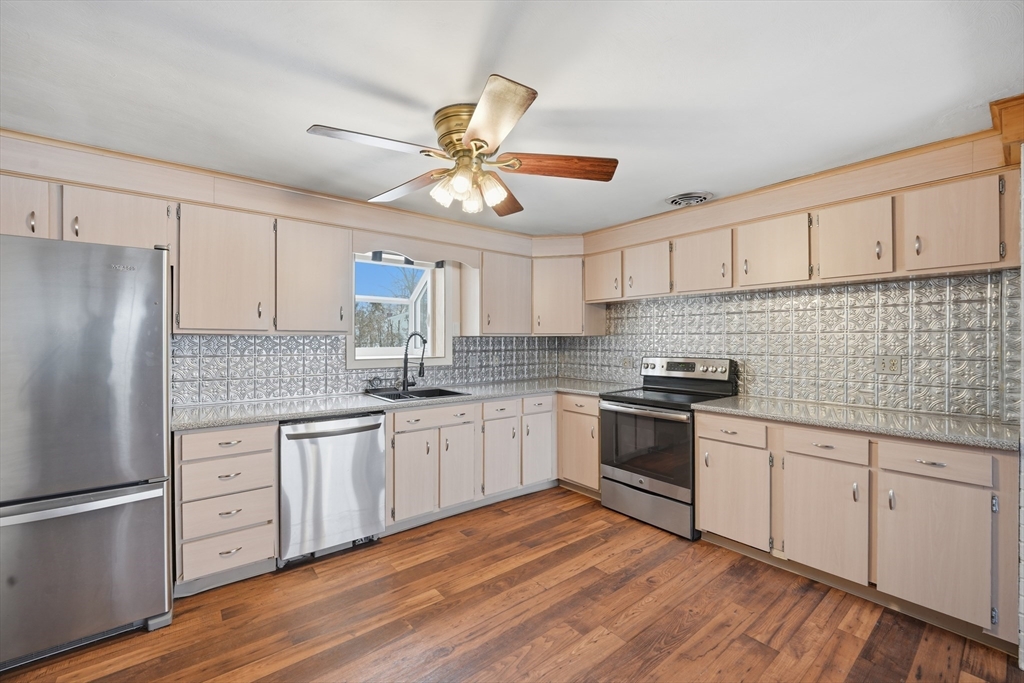 325 Granby Road Chicopee, MA 01013 - Photo 9 of 36 a kitchen with granite countertop a sink stainless steel appliances and cabinets
