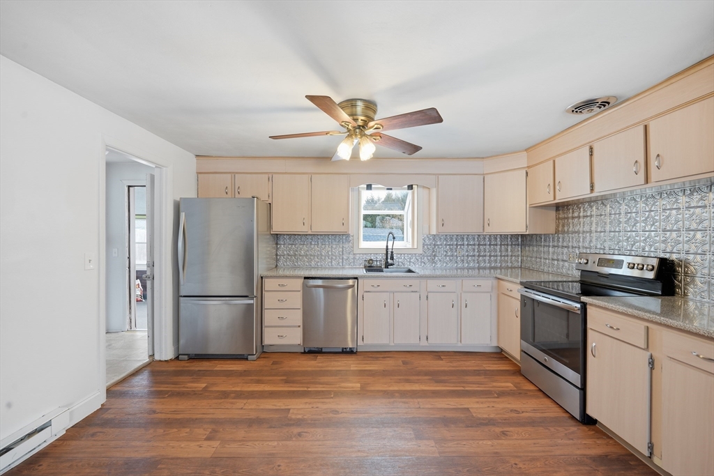 325 Granby Road Chicopee, MA 01013 - Photo 10 of 36 a kitchen with a refrigerator cabinets and wooden floor