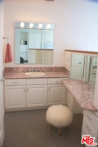a bathroom with a sink and mirror