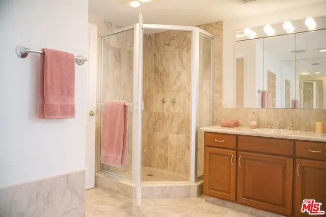 a bathroom with a shower and a sink