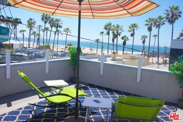 a view of a chair and tables in the patio