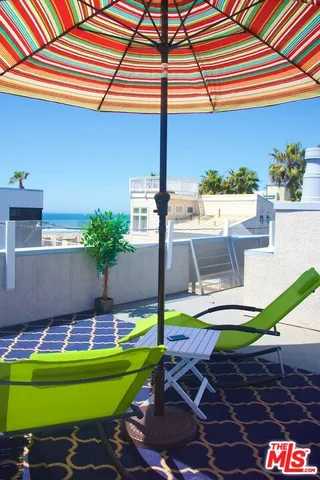 a swimming pool with lawn chairs