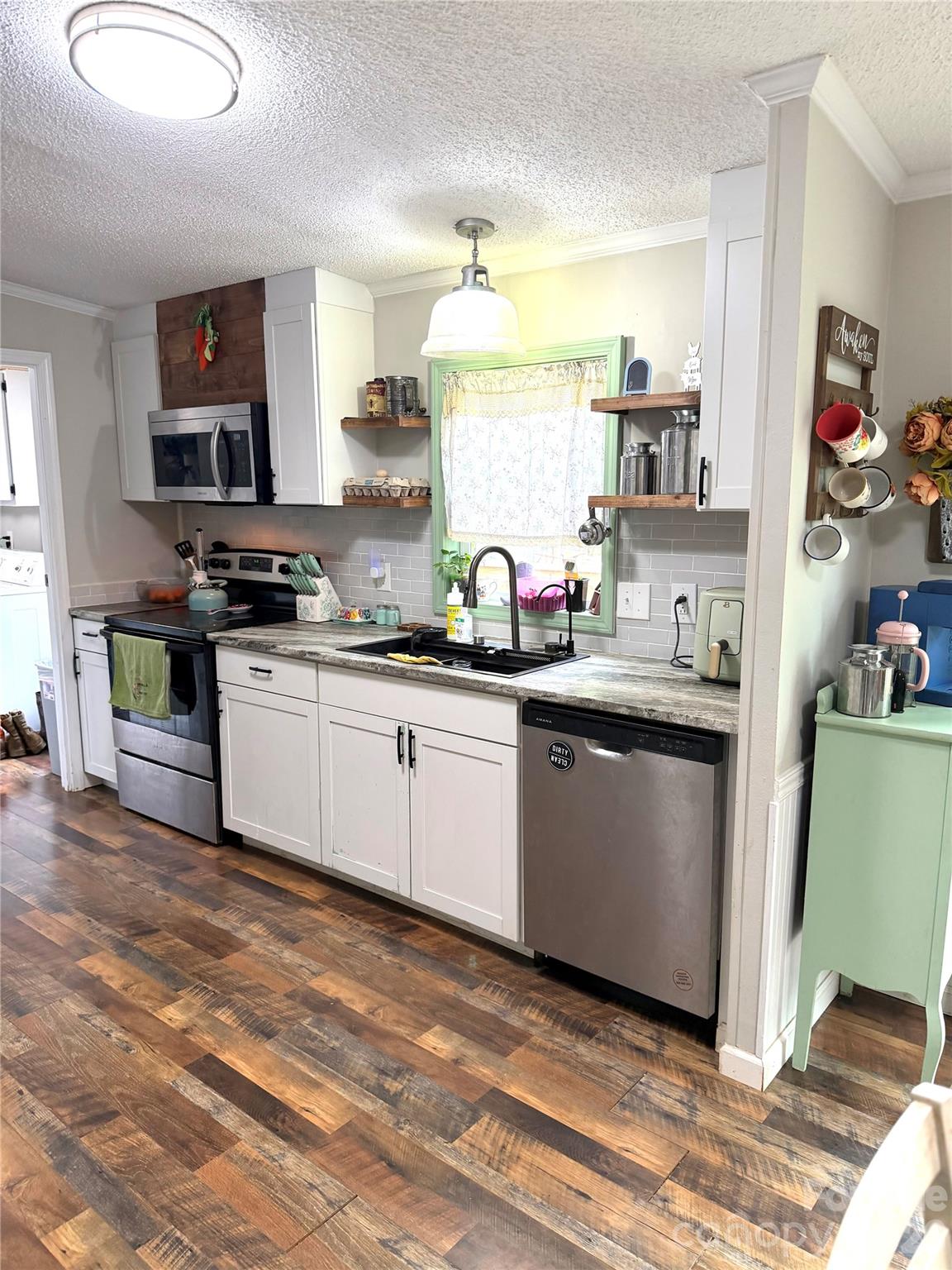 929 Brookhaven Road Statesville, NC 28625 - Photo 12 of 36 a kitchen with stainless steel appliances a sink stove and cabinets