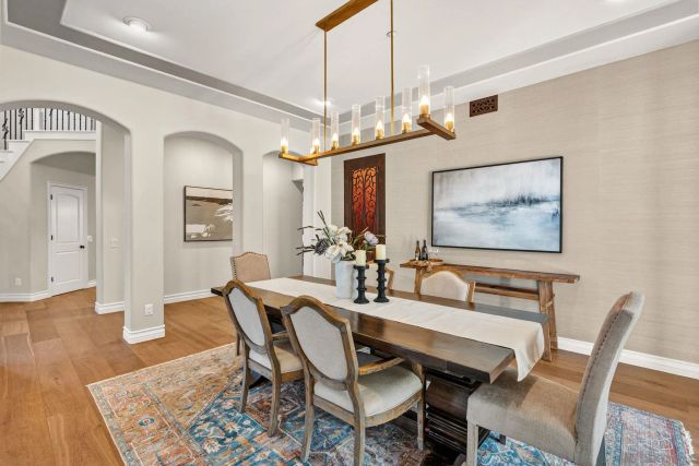 a view of a dining room with furniture and chandelier