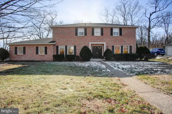 a front view of a house with a yard covered in snow