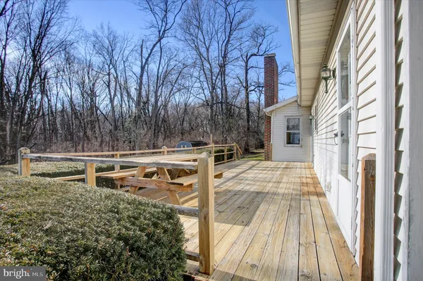 a front view of a house with a yard covered with snow