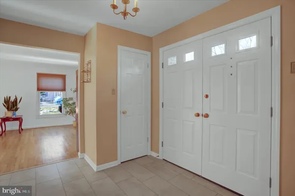 a view of a a dining room with furniture window and wooden floor