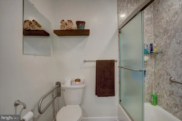 a kitchen with stainless steel appliances granite countertop white cabinets and a stove a oven with white countertops