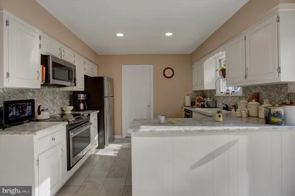 a bedroom with a bed a desk and chair