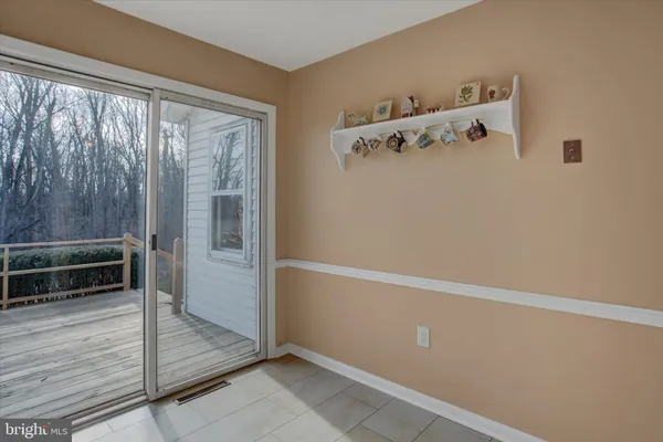 a bedroom with a bed table closet and a window