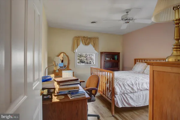 a bathroom with a granite countertop toilet a sink and a mirror