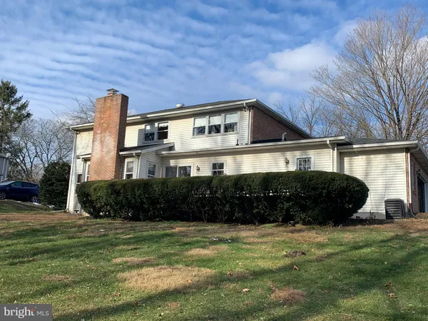 a view of backyard with barbeque grill and wooden fence
