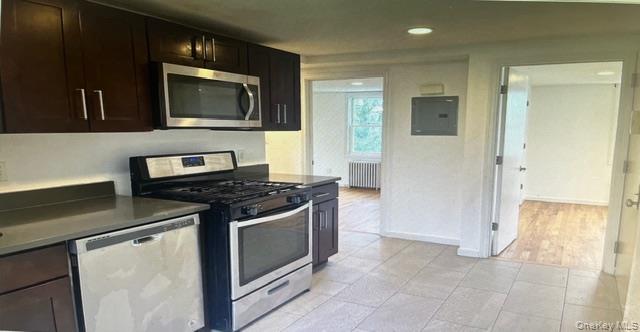 45 James Street Inwood, NY 11096 - Photo 6 of 11 a kitchen with a stove and a microwave