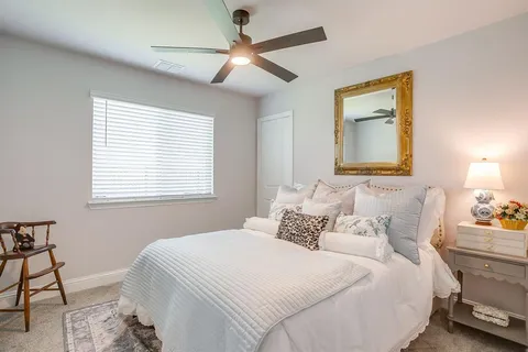 a bedroom with a bed and a chandelier