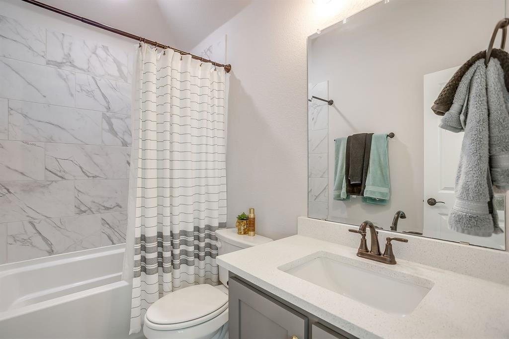 833 Godley Road Godley, TX 76044 - Photo 18 of 22 a bathroom with a sink toilet and shower