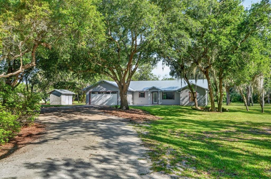 171 William Street Edgewater, FL 32141 - Photo 2 of 40 a front view of a house with a garden