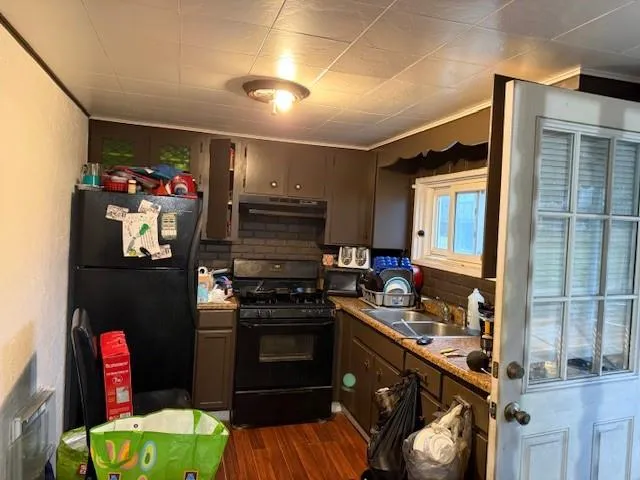 a kitchen with a stove and a refrigerator
