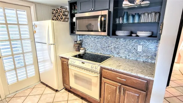 a view of a dining room with furniture and a window