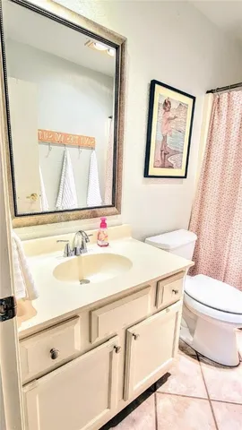 a bedroom with a bed and a lamp next to a window