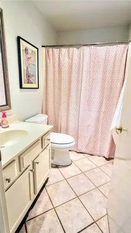 a view of a bedroom with furniture and window