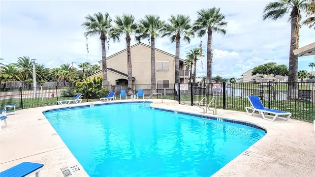 a view of swimming pool with a table and chairs