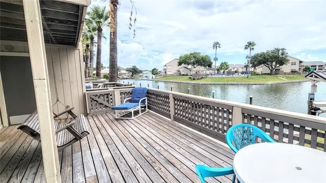 a view of a roof deck with wooden floor and outdoor seating