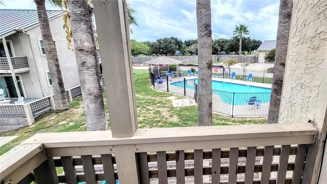 a living room with furniture a flat screen tv and a large window