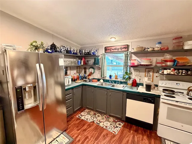 a kitchen with refrigerator and cabinets