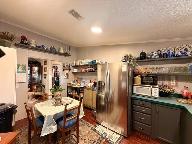 a kitchen with stainless steel appliances granite countertop a refrigerator and microwave