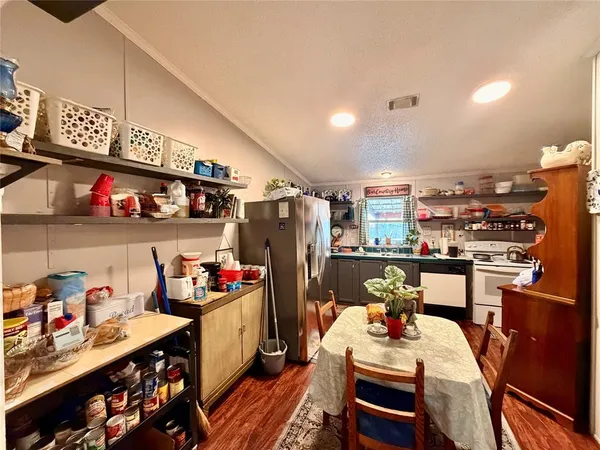 a kitchen with stainless steel appliances kitchen island granite countertop a refrigerator and a stove