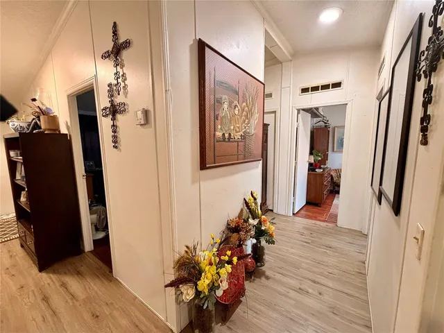 a view of a hallway with wooden floor and stairs